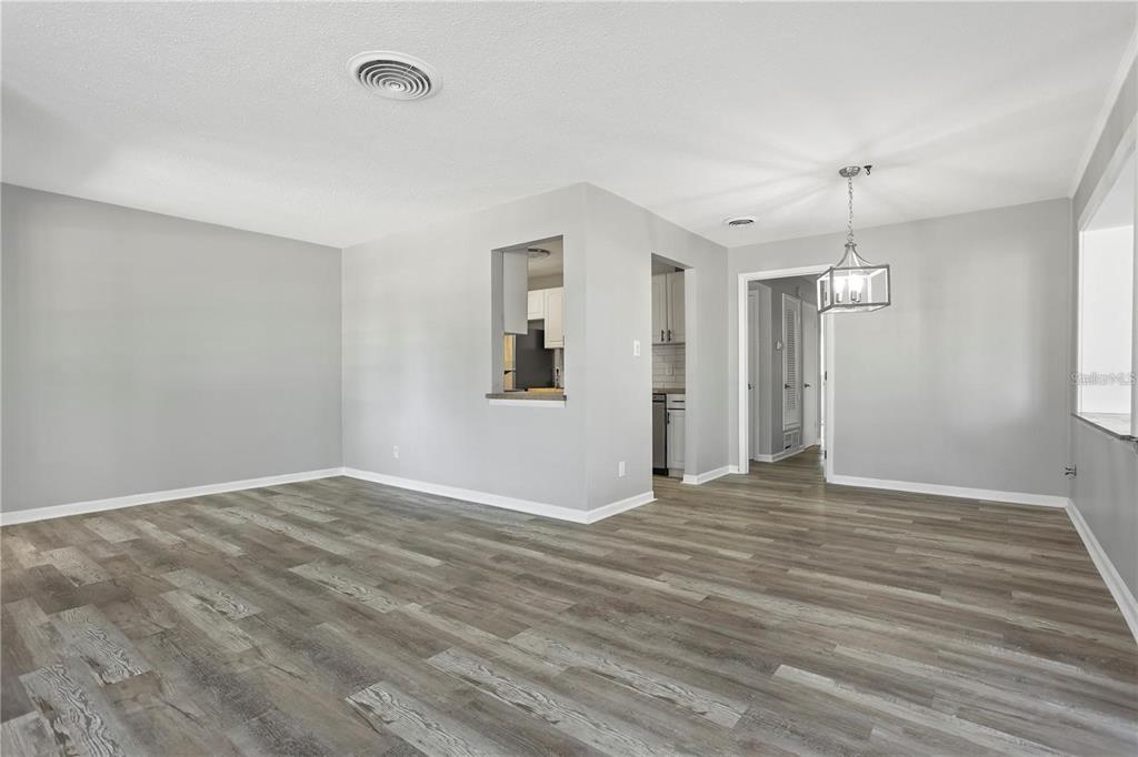 6615 Renssalaer Drive Bradenton, FL 34207 - Photo 13 of 31 a view of an empty room with window and wooden floor