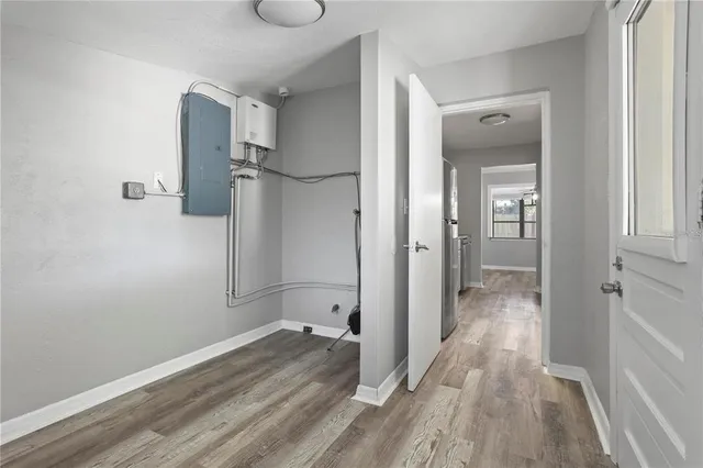 a view of a room with wooden floor and a bathroom