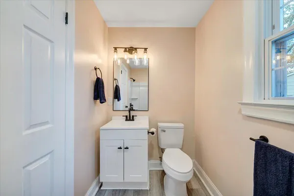 a bathroom with a toilet sink and mirror