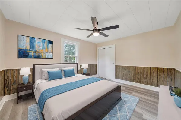a bedroom with a large bed and a chandelier