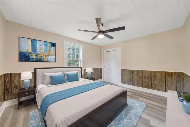 a bedroom with a large bed and a chandelier