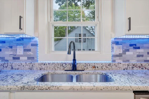 a kitchen with granite countertop a sink and a granite counter top