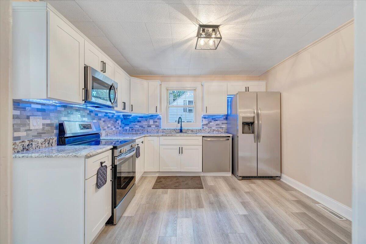 1433 Chalk Level Road Chatham, VA 24531 - Photo 19 of 41 a kitchen with stainless steel appliances granite countertop a stove a sink dishwasher and a refrigerator