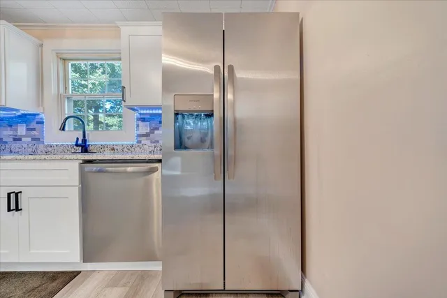a kitchen with a refrigerator and a sink