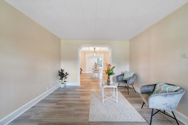 a living room with furniture and a chandelier