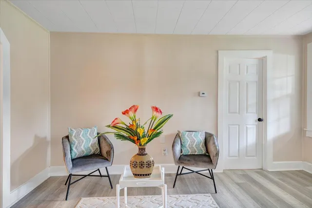 a dining room with furniture and wooden floor