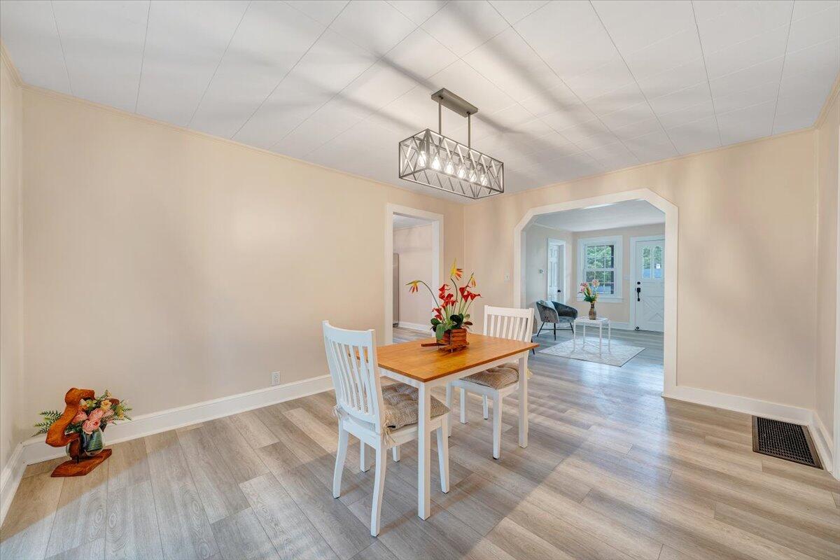 1433 Chalk Level Road Chatham, VA 24531 - Photo 27 of 41 a dining room with furniture a chandelier and wooden floor