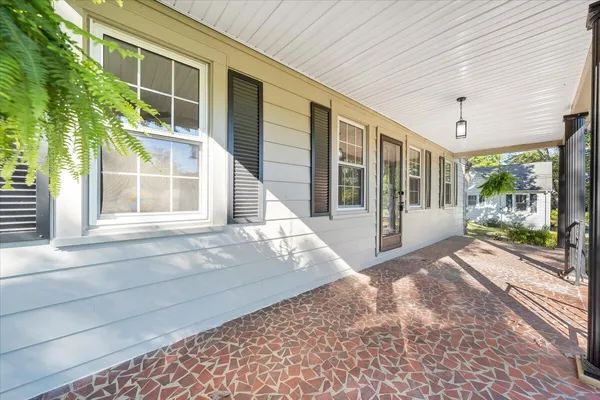 a view of a brick house with large windows