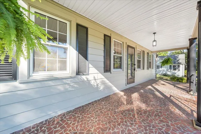 a view of a brick house with large windows