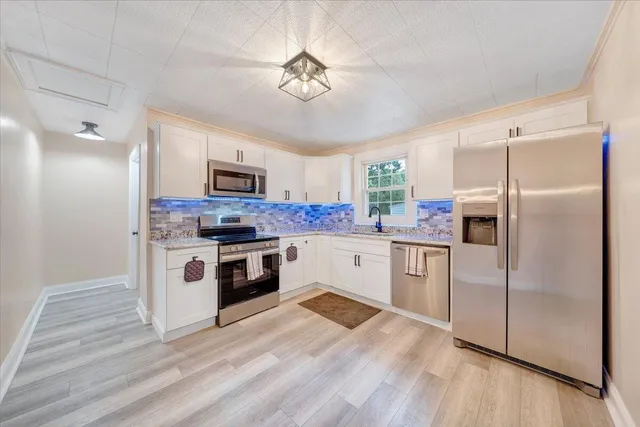 a kitchen with a refrigerator stove and microwave