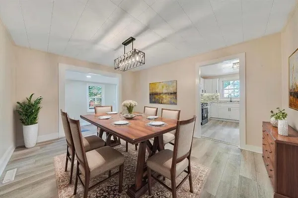 a view of a dining room with furniture and wooden floor