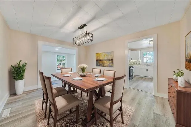 a view of a dining room with furniture and wooden floor
