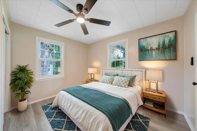 a bedroom with a bed and a potted plant