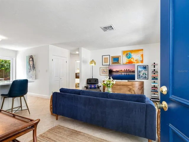 a living room with furniture and painting on the wall