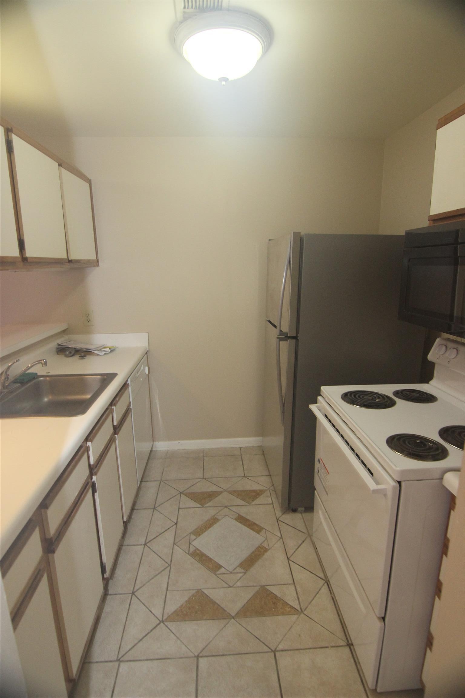 1245 Old Lascassas Road, Unit F Murfreesboro, TN 37130 - Photo 4 of 9 a kitchen that has a sink and a stove