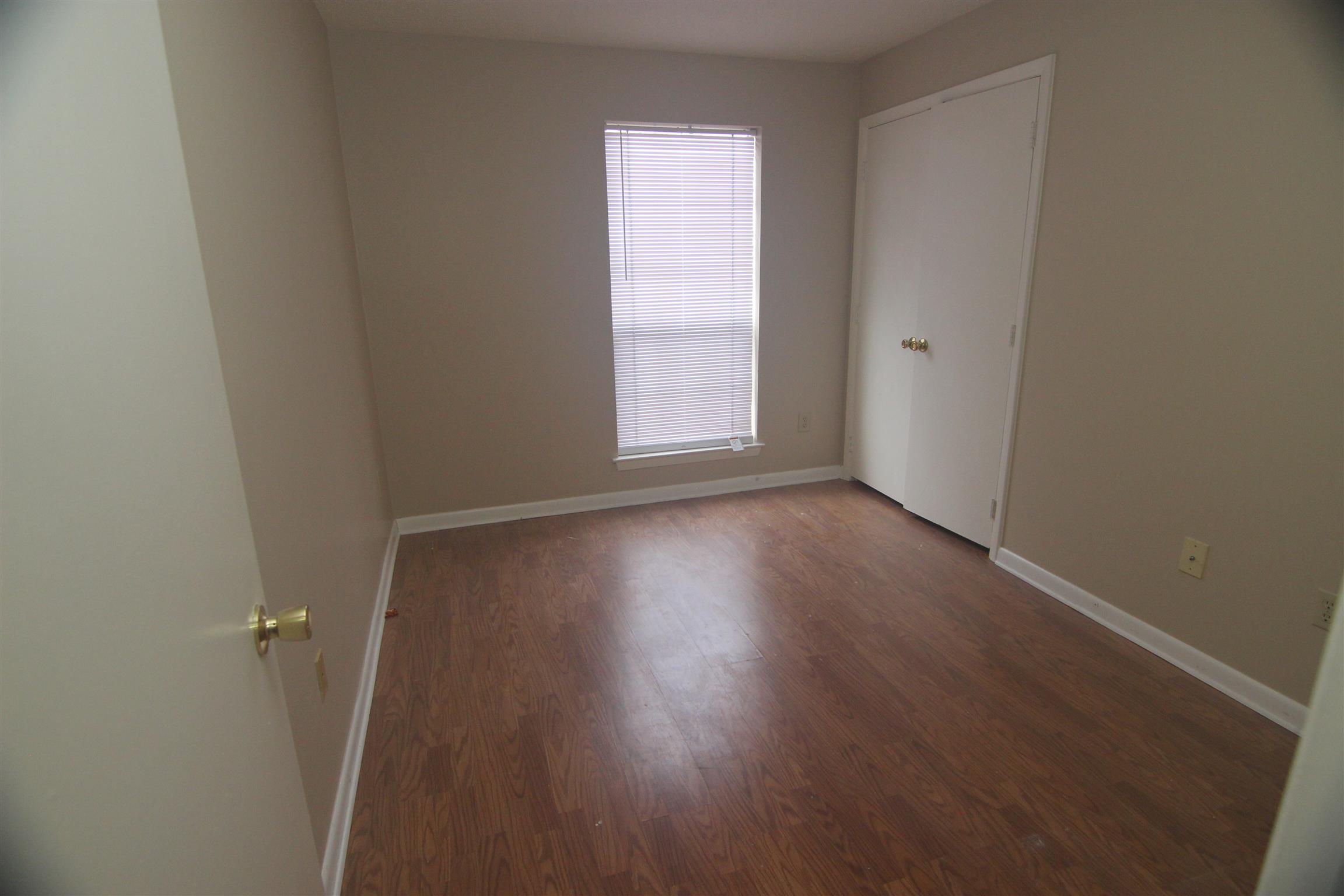 1245 Old Lascassas Road, Unit F Murfreesboro, TN 37130 - Photo 5 of 9 an empty room with wooden floor and windows