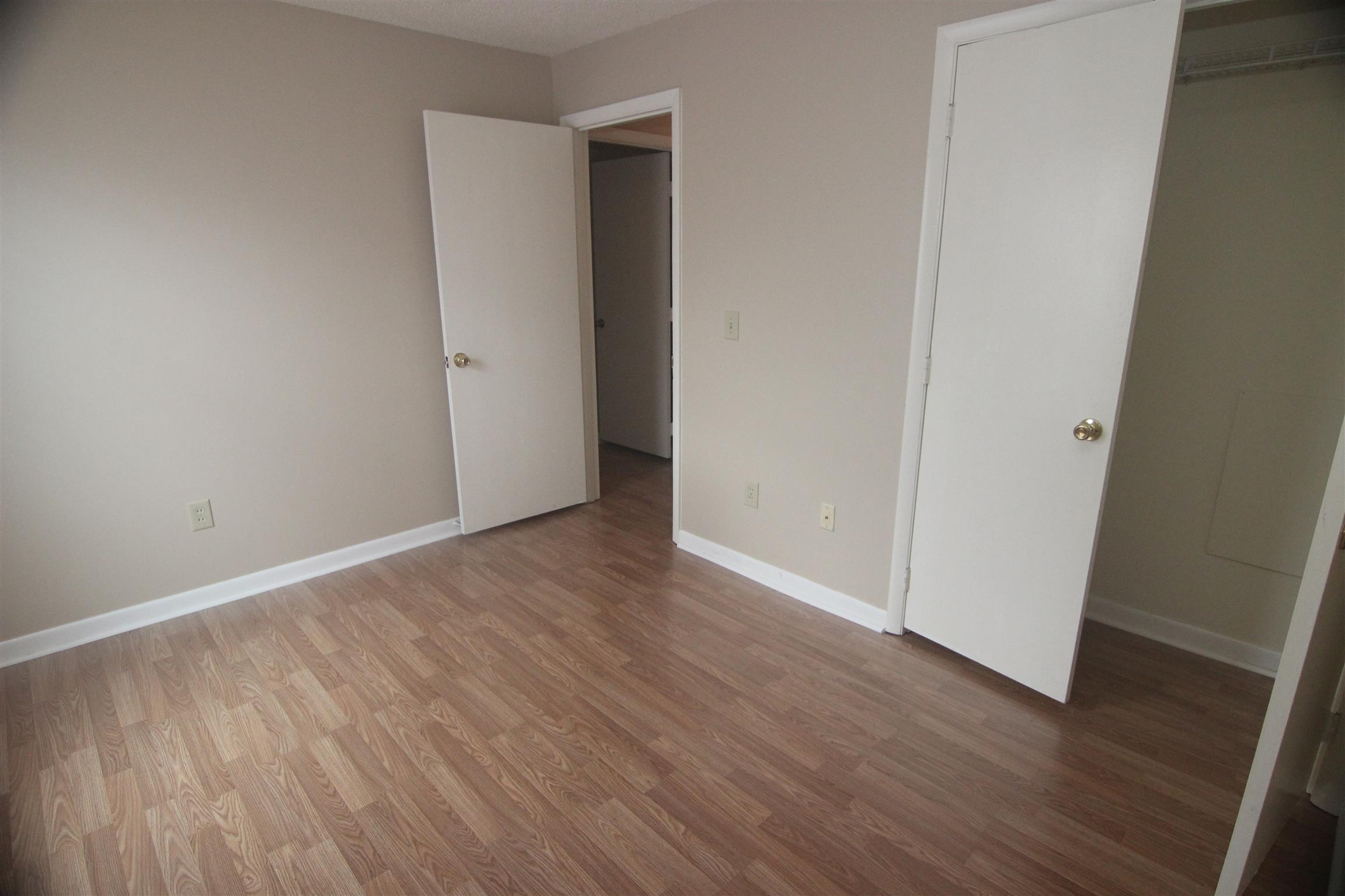 1245 Old Lascassas Road, Unit F Murfreesboro, TN 37130 - Photo 8 of 9 a view of an empty room with wooden floor