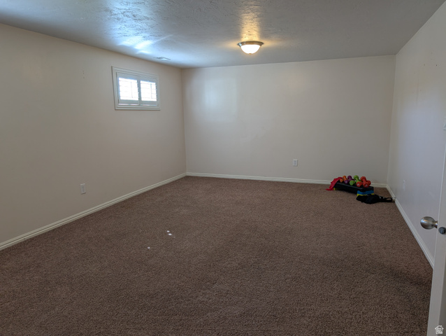 1411 Millbrook Way Bountiful, UT 84010 - Photo 29 of 36 Spacious multipurose room featuring neutral carpeting, light-toned walls, and a single window with plantation-style shutters