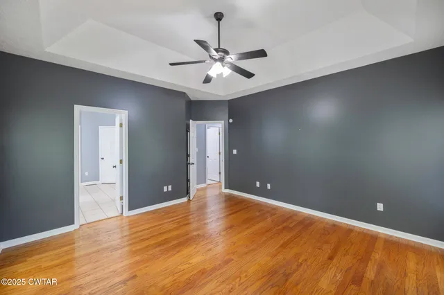 a view of an empty room with a ceiling fan