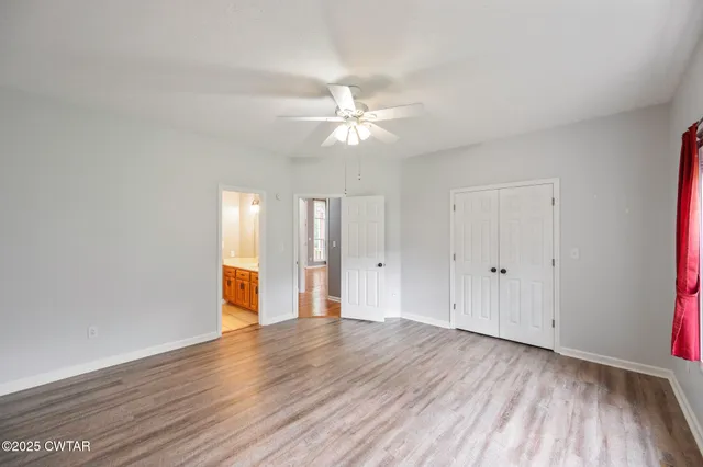 a view of an empty room window and wooden floor