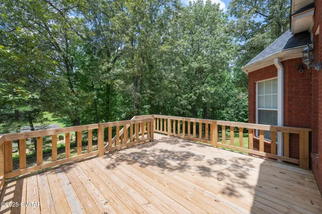 a balcony with wooden floor and fence