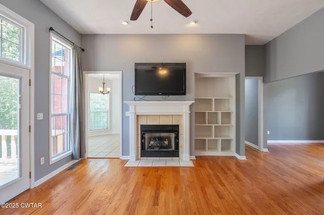 a living room with a fireplace and a flat screen tv