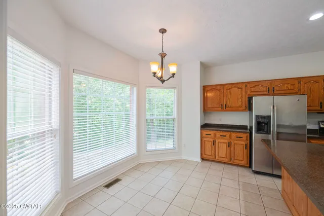 a view of a room window and kitchen view