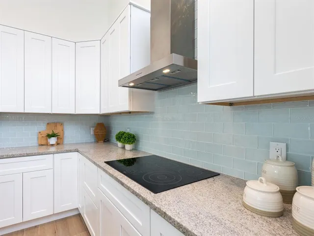 a kitchen with stainless steel appliances granite countertop a sink and a refrigerator