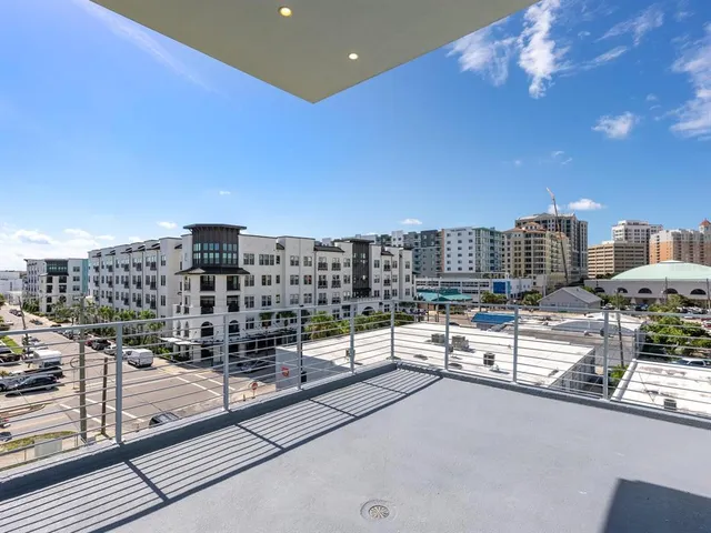 a view of building with cars parked