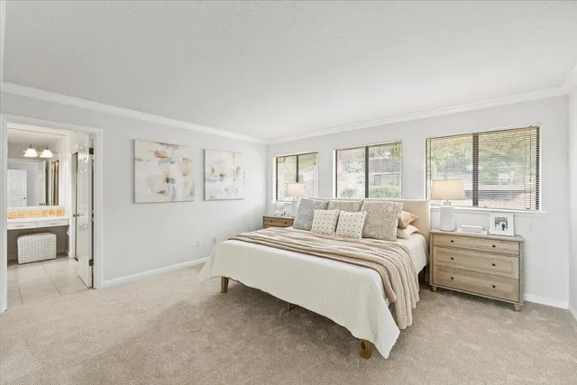 a bedroom with a large bed and a painting on the wall