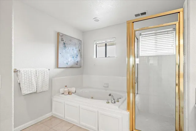 a bathroom with a tub sink and mirror