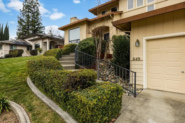 a front view of a house with garden