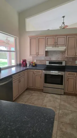 a kitchen with stainless steel appliances granite countertop a sink and cabinets