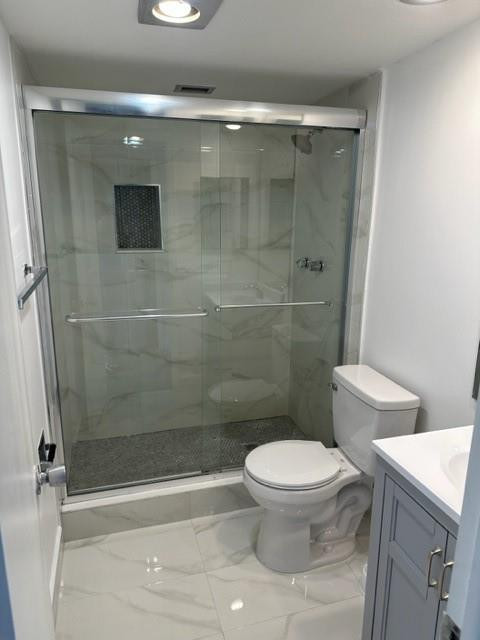 2650 South Course Drive, Unit 603 Pompano Beach, FL 33069 - Photo 11 of 25 a bathroom with a toilet and a shower
