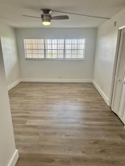 2650 South Course Drive, Unit 603 Pompano Beach, FL 33069 - Photo 13 of 25 a view of an empty room with wooden floor and windows