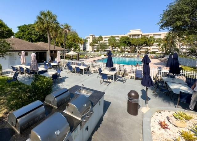 2650 South Course Drive, Unit 603 Pompano Beach, FL 33069 - Photo 18 of 25 a view of a swimming pool with lounge chairs