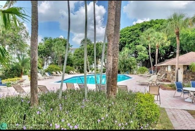 2650 South Course Drive, Unit 603 Pompano Beach, FL 33069 - Photo 20 of 25 a view of a backyard with plants and outdoor seating
