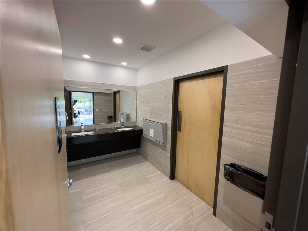2650 South Course Drive, Unit 603 Pompano Beach, FL 33069 - Photo 21 of 25 a living room with a couch and a dresser next to a window