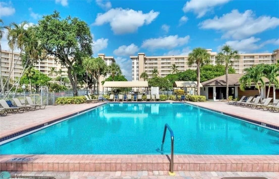 2650 South Course Drive, Unit 603 Pompano Beach, FL 33069 - Photo 24 of 25 a swimming pool with outdoor seating and yard
