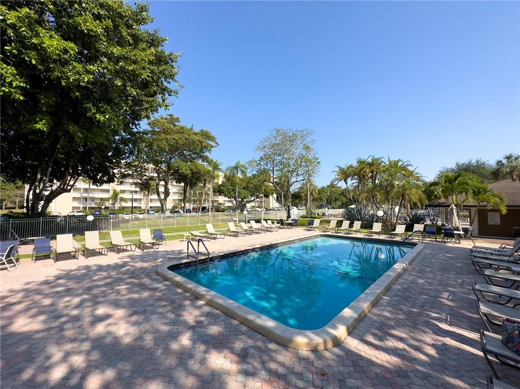2650 South Course Drive, Unit 603 Pompano Beach, FL 33069 - Photo 25 of 25 a view of swimming pool with outdoor seating and plants