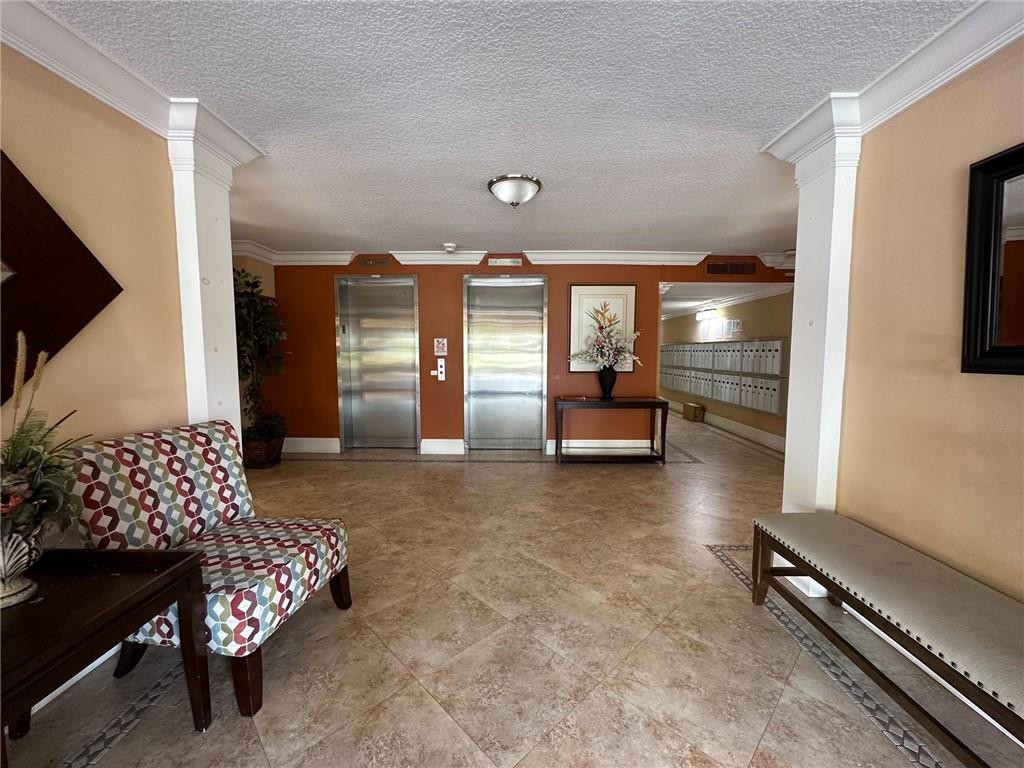 2650 South Course Drive, Unit 603 Pompano Beach, FL 33069 - Photo 4 of 25 a lobby with furniture and window