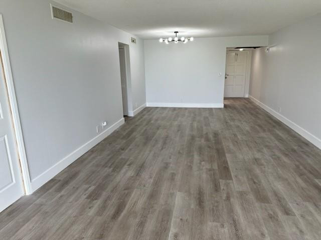 2650 South Course Drive, Unit 603 Pompano Beach, FL 33069 - Photo 6 of 25 an empty room with wooden floor and windows