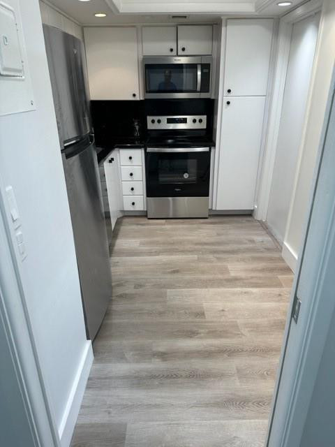 2650 South Course Drive, Unit 603 Pompano Beach, FL 33069 - Photo 7 of 25 a view of kitchen and microwave