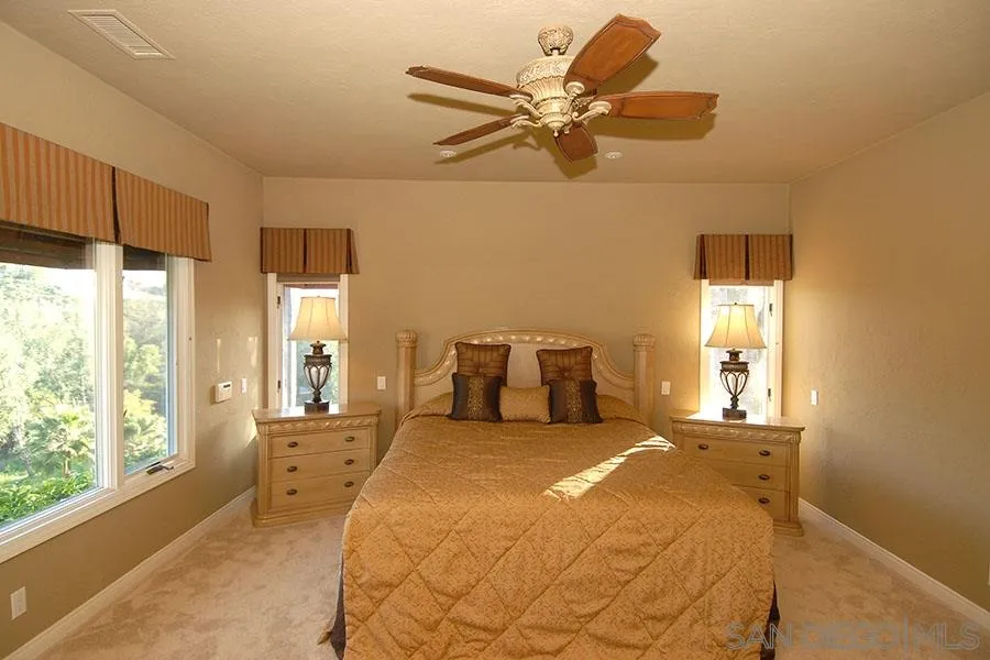 6515 Poco Lago Rancho Santa Fe, CA 92091 - Photo 11 of 25 a bedroom with a large bed and a window