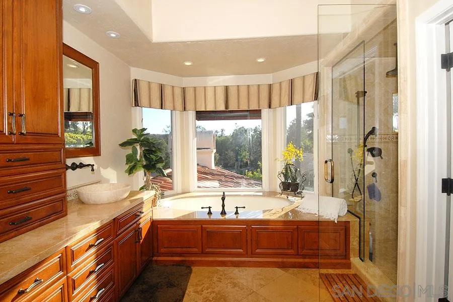 6515 Poco Lago Rancho Santa Fe, CA 92091 - Photo 13 of 25 a large bathroom with a large tub and sink