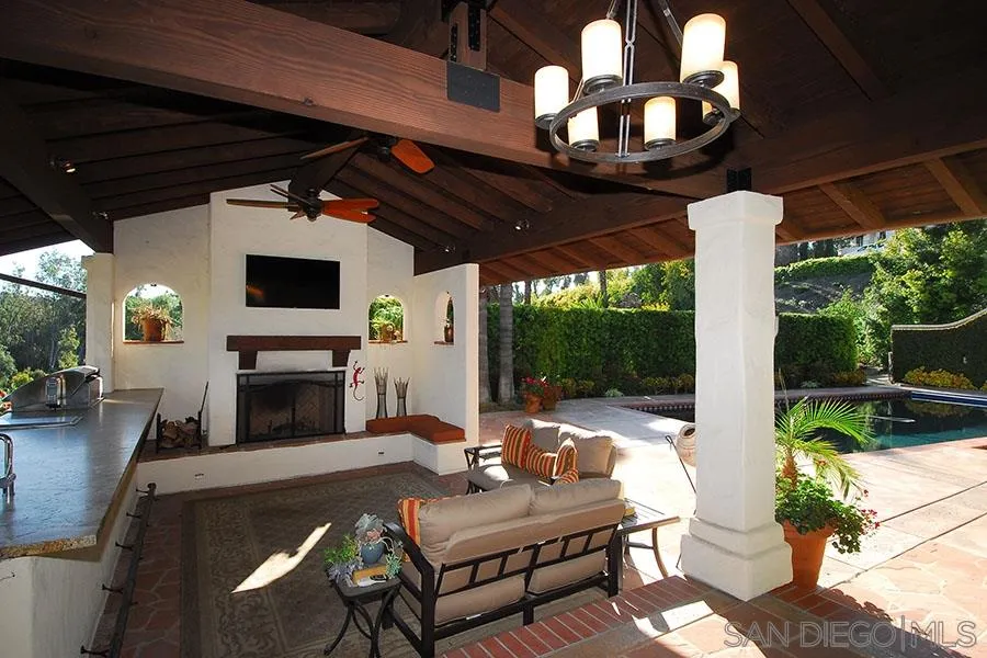 6515 Poco Lago Rancho Santa Fe, CA 92091 - Photo 4 of 25 a living room with furniture a fireplace and a floor to ceiling window