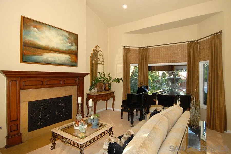 6515 Poco Lago Rancho Santa Fe, CA 92091 - Photo 7 of 25 a living room with furniture a fireplace and a flat screen tv