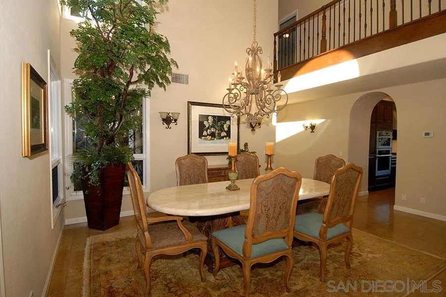 6515 Poco Lago Rancho Santa Fe, CA 92091 - Photo 9 of 25 a view of a dining room with furniture and a chandelier