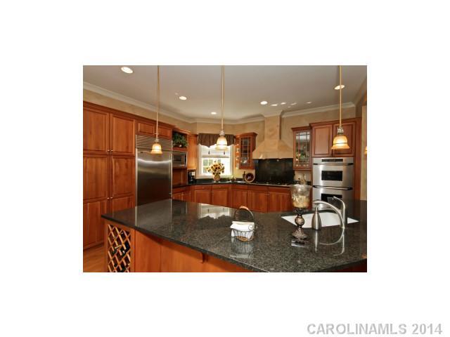 18804 Windy Point Drive Cornelius, NC 28031 - Photo 8 of 12 a kitchen view with stainless steel appliances a dining table and chairs