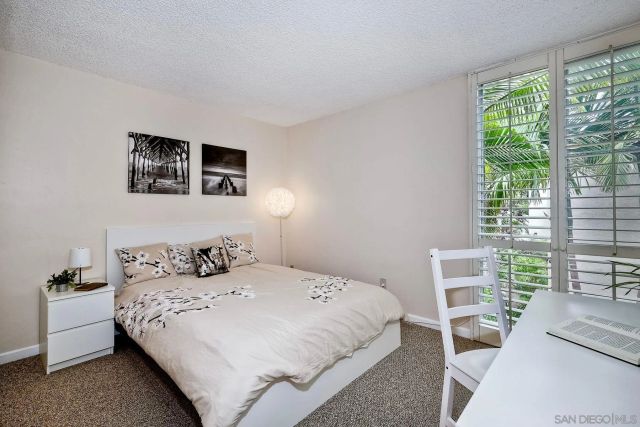 a bedroom with a bed and a lamp